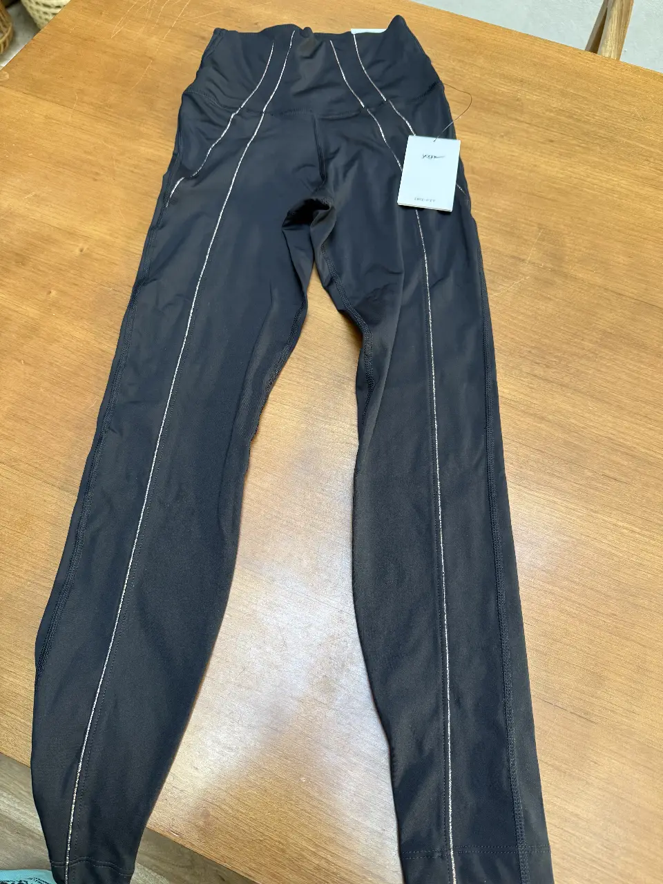 Calzas deportivas Nike Yoga Dri-FIT negras con detalles en plateado. Talle XS. Perfectas para yoga y entrenamiento.