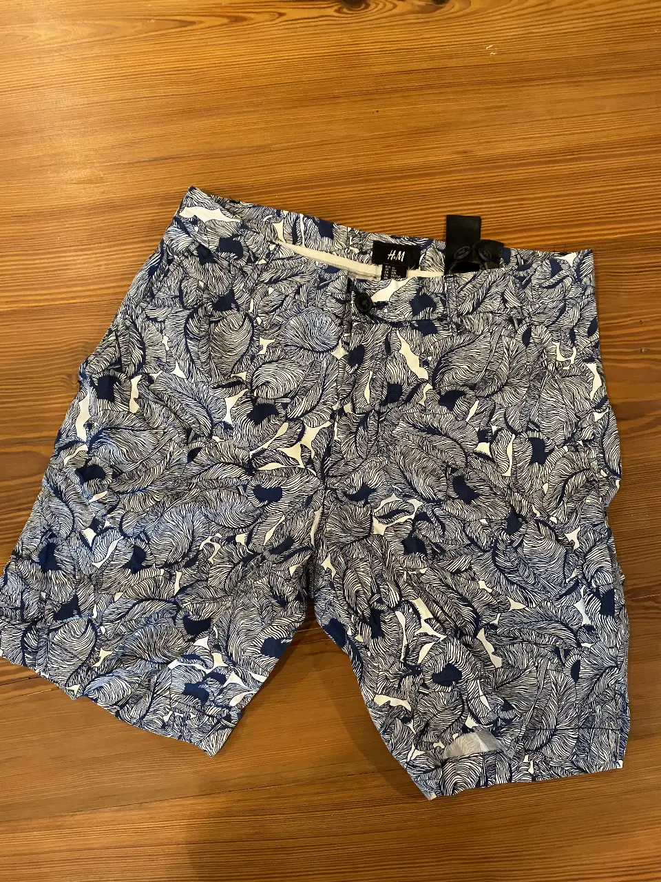 Short de hombre H&M con estampado de hojas en azul y blanco. Talle 30R, ideal para el verano. Perfecto para un look casual y fresco.