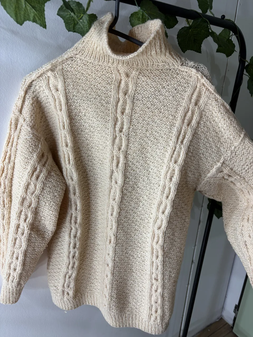 Sweater de lana tejido a mano, color crudo, con cuello alto y detalles de ochos en mangas y frente. Un clásico infalible para los días fríos.leves mancha