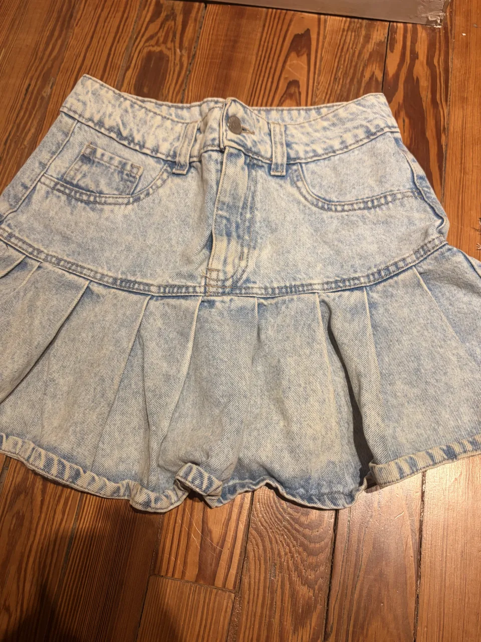 Pollera de jean tiro alto con tabla. Lavado desgastado.