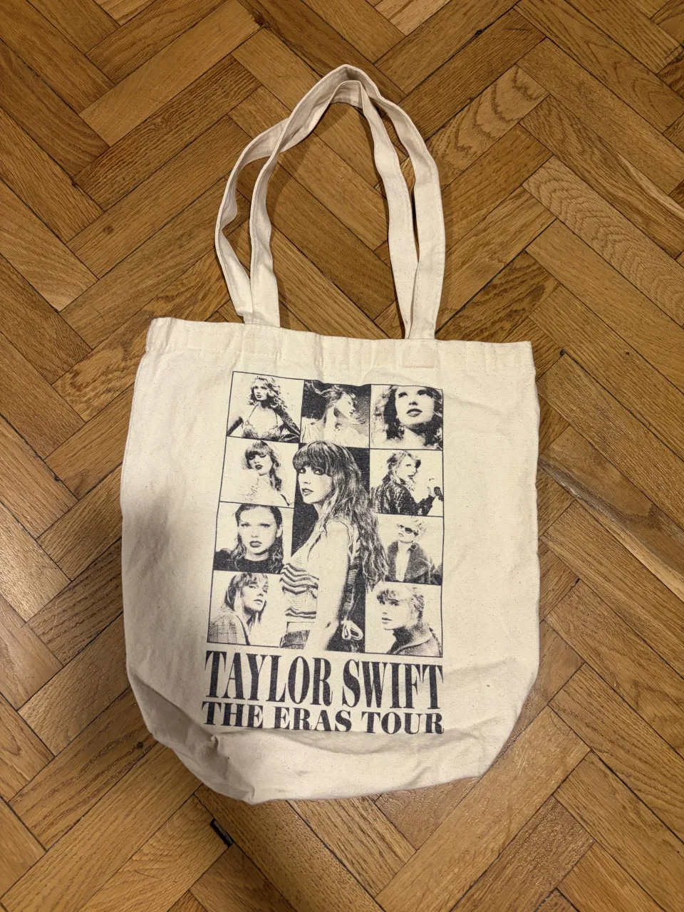 Bolso de tela color crudo con estampa de Taylor Swift "The Eras Tour" y fotos de la artista. En el reverso, la leyenda "TAYLOR SWIFT THE ERAS TOUR VIP". ORIGINAL del pack vip del tour.