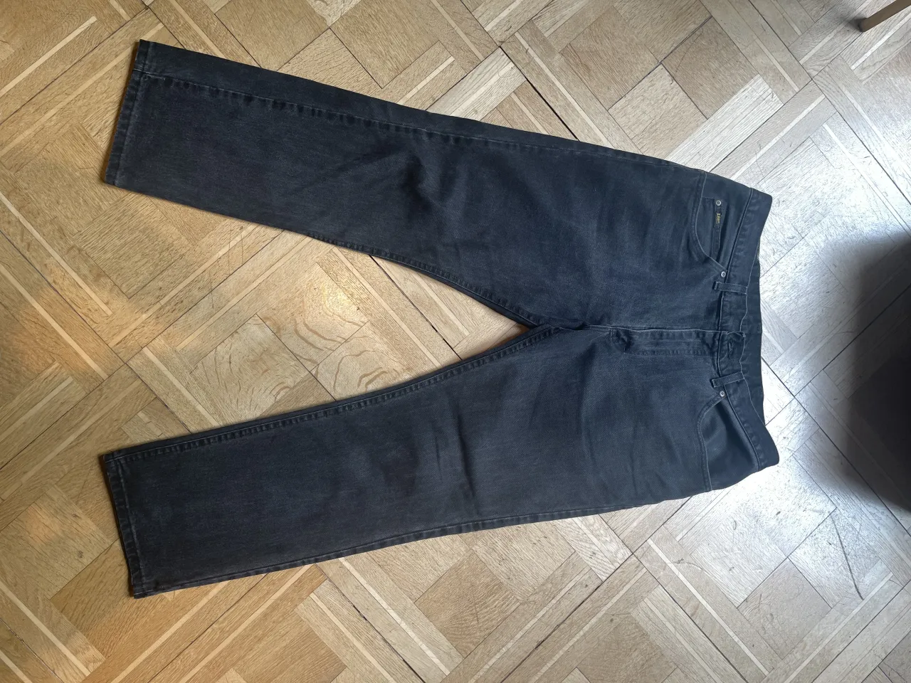 Jeans negros de corte clásico, con etiqueta de cuero en la parte trasera con el logo de la marca. TALLE 36x30