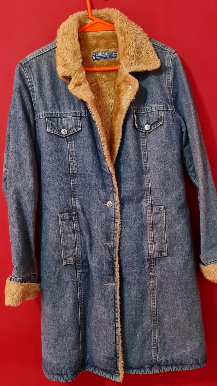 Campera de jean larga con forro de corderito súper abrigada. Ideal para los días fríos, con un estilo canchero y moderno. Perfecta para un look casual y cómodo.