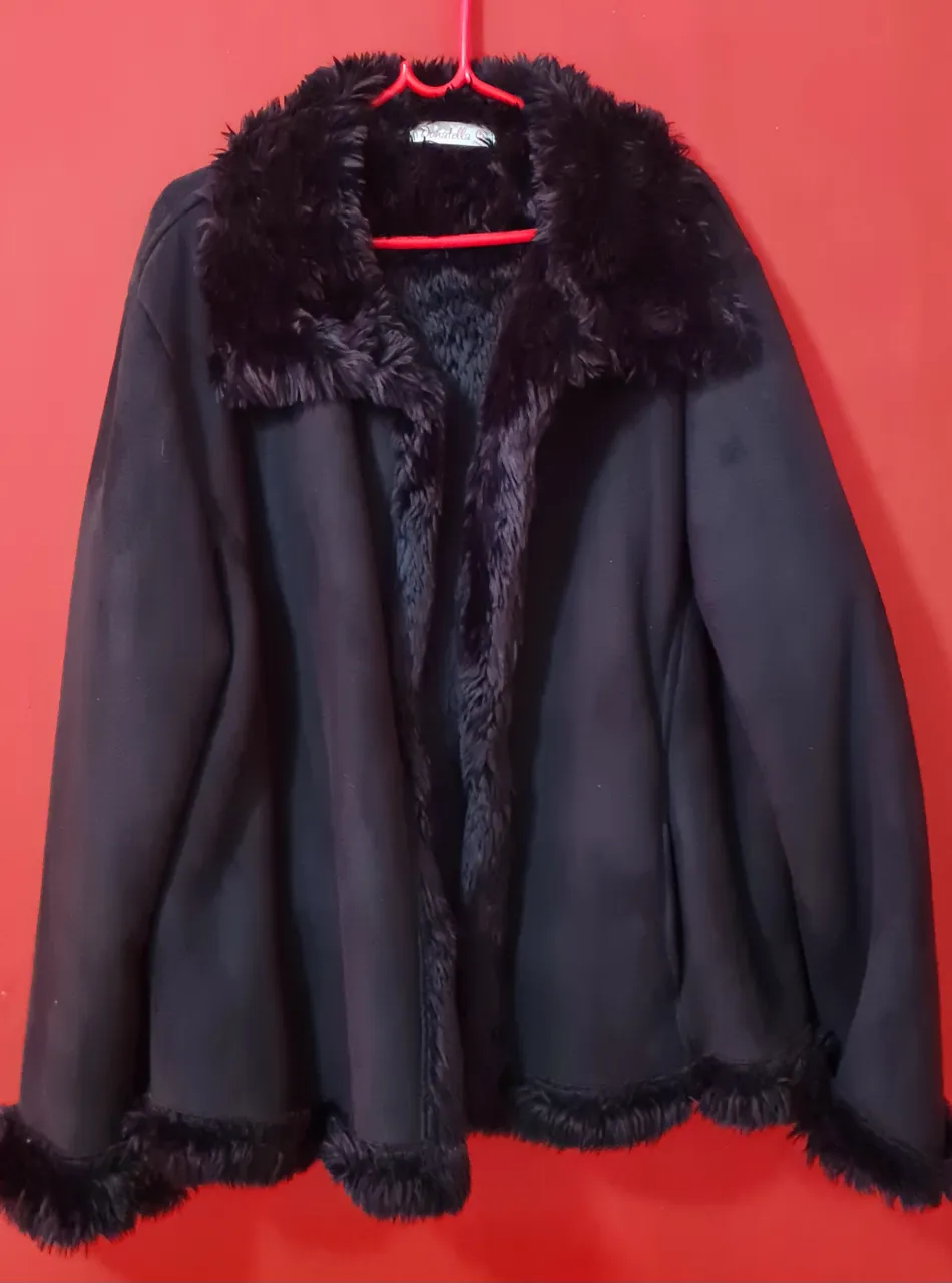 Campera negra de paño con cuello y puños de piel sintética. Ideal para el frío, con un estilo moderno y abrigado.