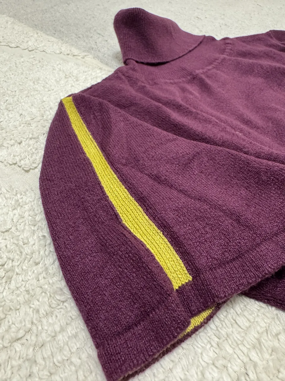 Sweater de bremer manga corta con cuello. Detalles en verde lima en las mangas y en el cuello. Posee una franja verde lima en la parte de abajo, en cada manga y un detalle amarillo en el borde del cuello. 