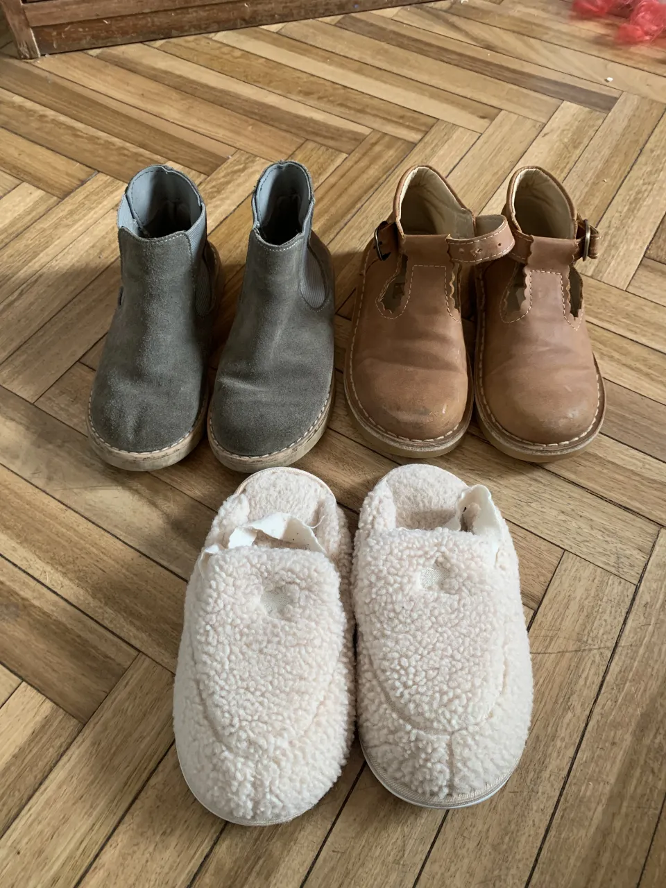 Lote de botitas grises con elástico lateral cheeky ,par de pantuflas de peluche color crema babycottons, También se incluye un par de zapatos marrones con hebilla tipo guillerminas. todos talle 28 argentina 