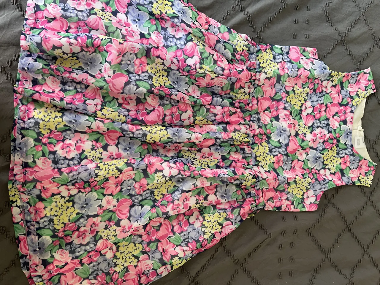 Vestido de niña con estampa floral vibrante en tonos rosas, azules y amarillos. Ideal para eventos o para el día a día en primavera y verano. Un modelo fresco y alegre que encantará a las más pequeñas.