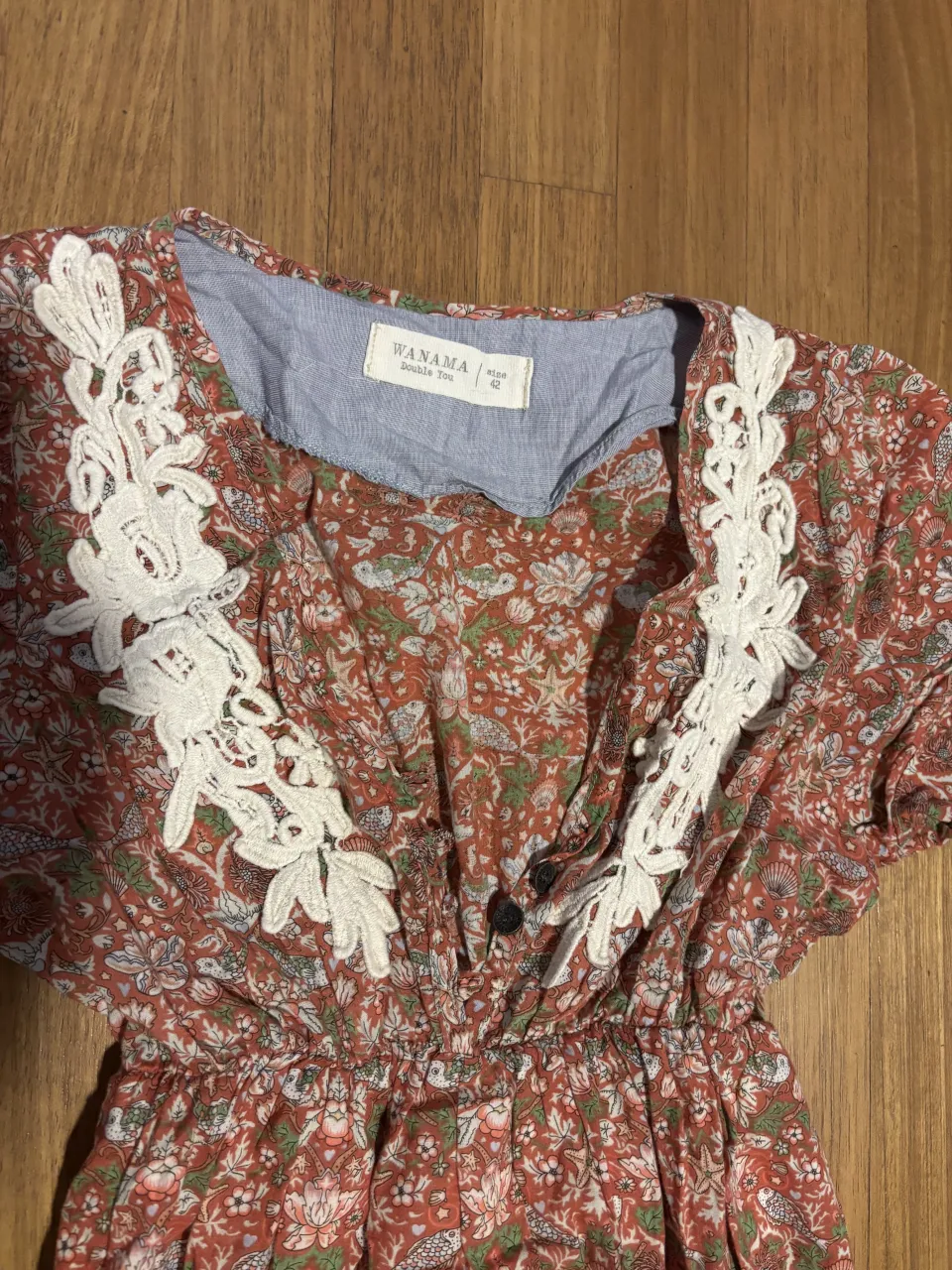 Vestido largo estampado floral con detalles de encaje blanco en el escote y en el ruedo. Posee mangas cortas y un corte en la cintura que le da movimiento a la falda. Ideal para un look romántico y fresco.