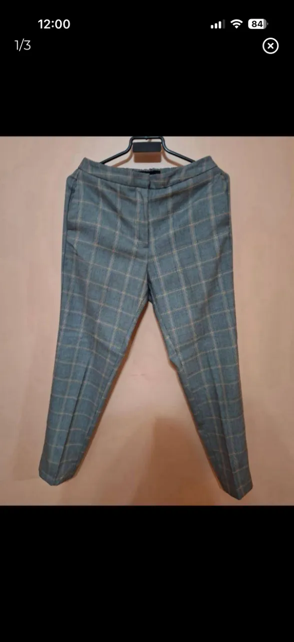 Pantalón de vestir a cuadros, tiro alto, con bolsillos y corte recto. Ideal para un look elegante y formal.